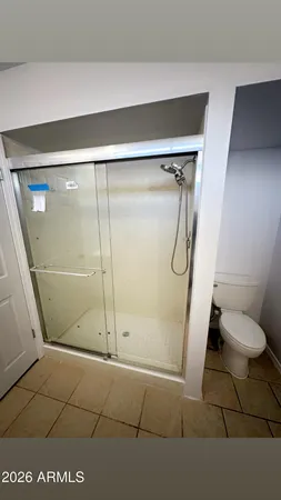 a bathroom with a glass shower door