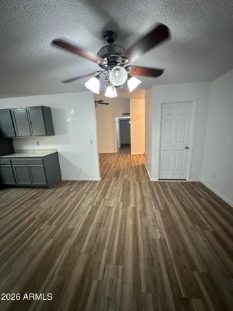 a spacious bedroom with a bed and a chandelier