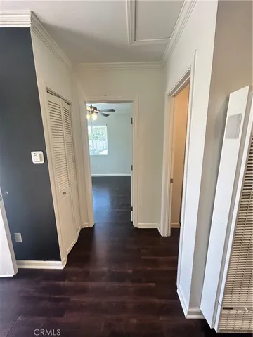 an empty room with wooden floor and stairs