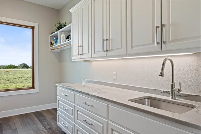 a kitchen with lots of clutter and cabinets