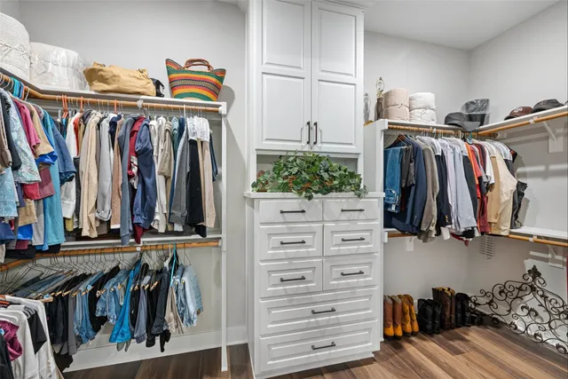 a large white kitchen with granite countertop a refrigerator and a sink