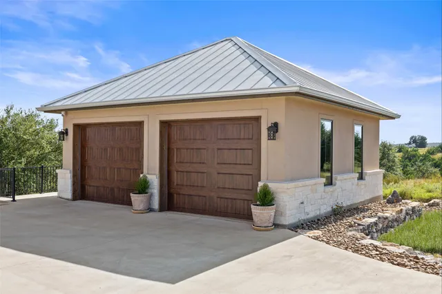 a view of a house with porch and wooden fence