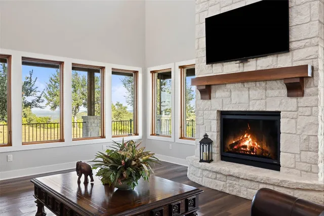 a living room with furniture fireplace and flat screen tv
