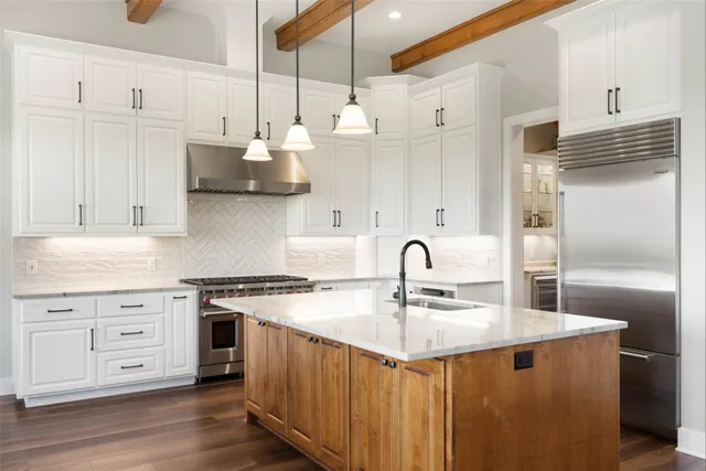 a kitchen with stove a sink and cabinets