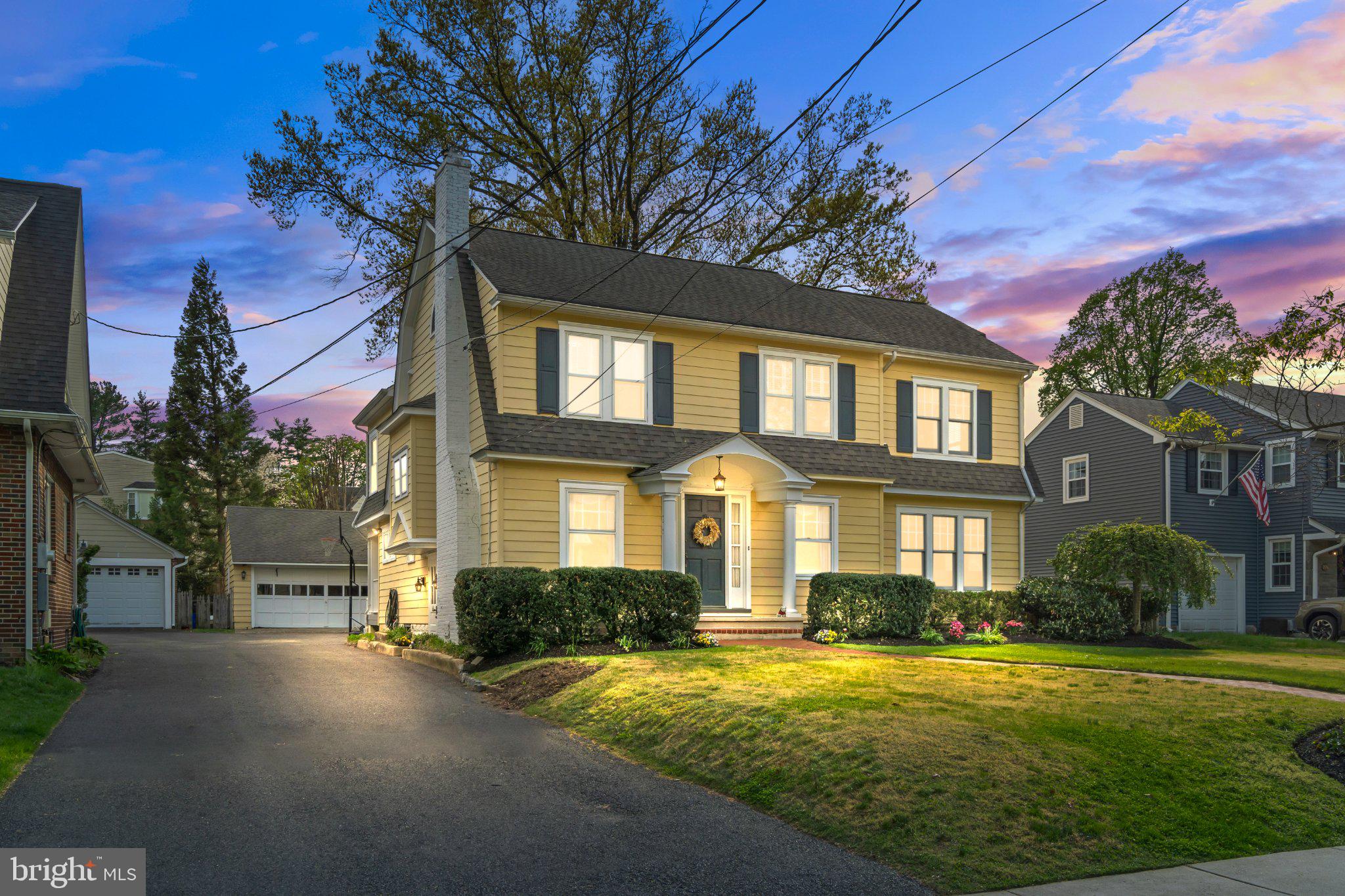 a front view of a house with a yard and outdoor seating