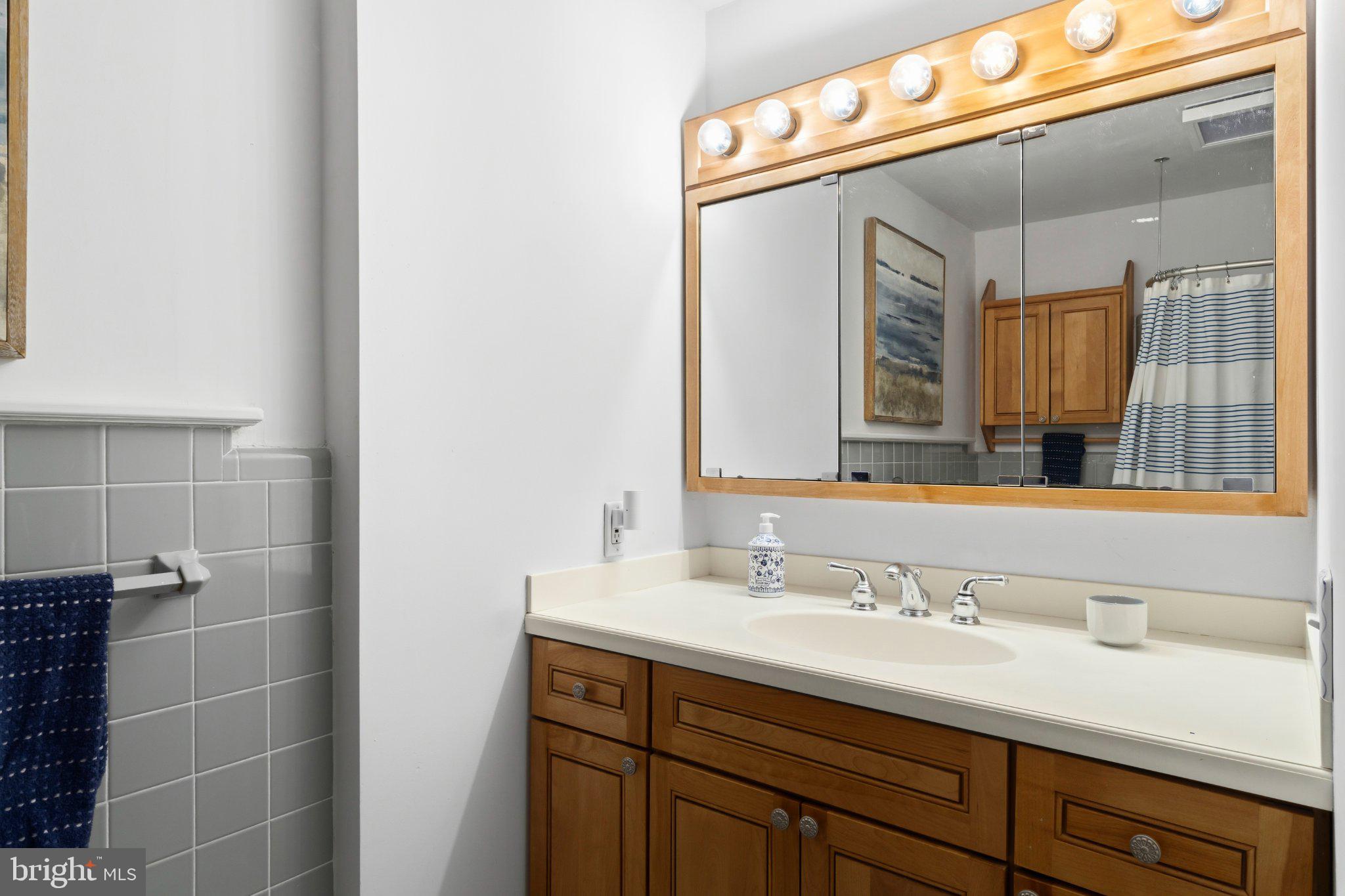 272 Jefferson Avenue Haddonfield, NJ 08033 - Photo 29 of 43 a bathroom with a sink and a mirror