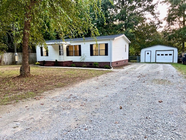 a view of a house with a yard and trees