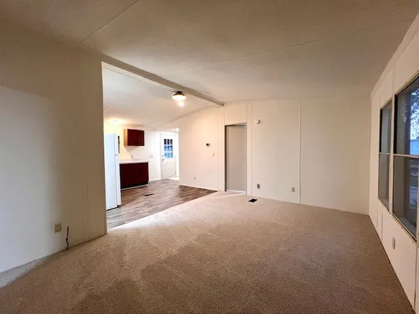 a view of empty room with a fireplace