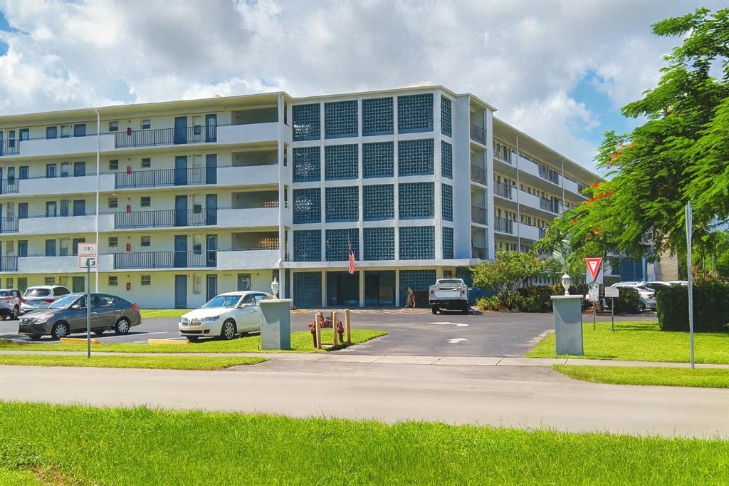 950 Hillcrest Drive, Unit 202 Hollywood, FL 33021 - Photo 2 of 19 a front view of a building with a garden and plants