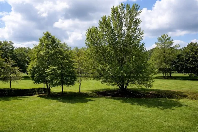 a kitchen with a refrigerator a stove and a sink with wooden floor