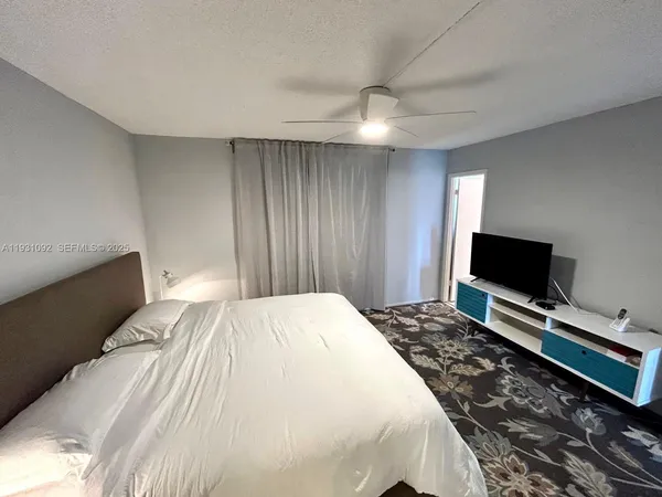 a bedroom with a bed and a flat screen tv