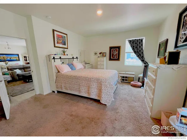 a bedroom with a bed a couch and dresser