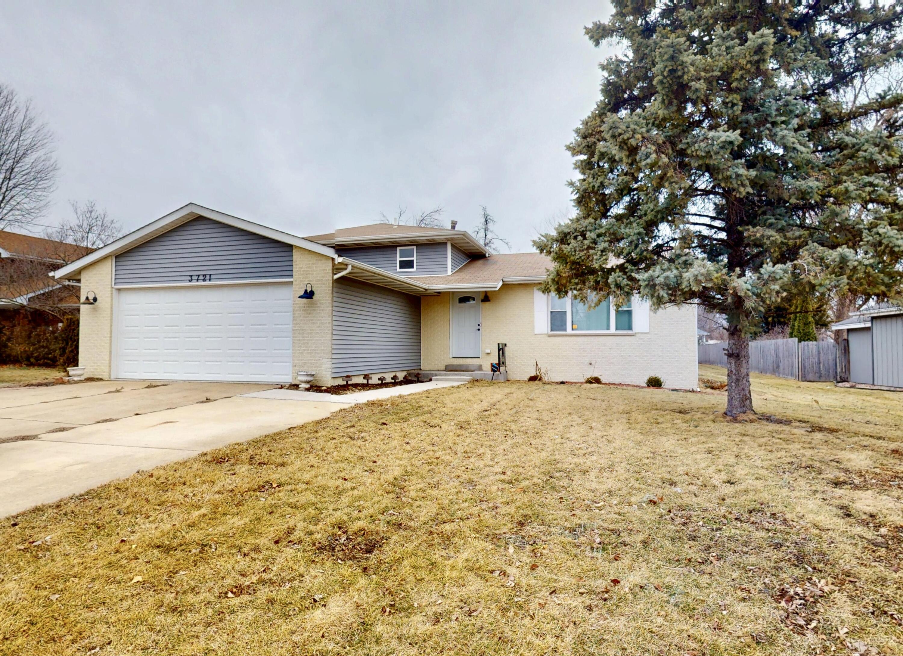 a view of a house with a yard and garage
