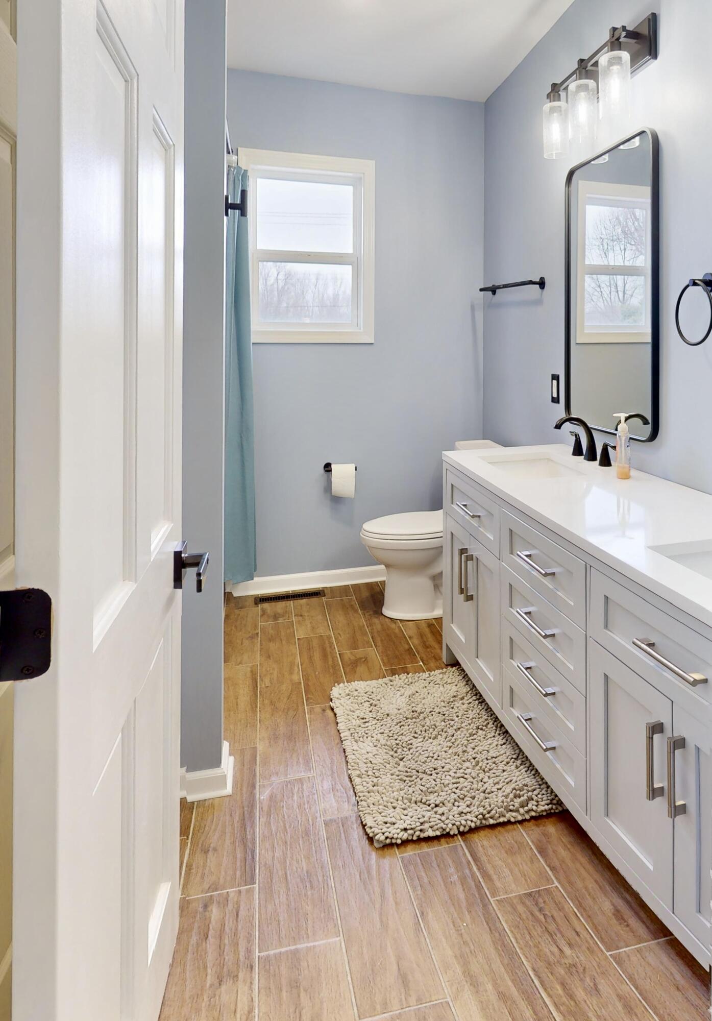 3721 Wirth Road Highland, IN 46322 - Photo 12 of 40 a bathroom with a sink a mirror and a toilet