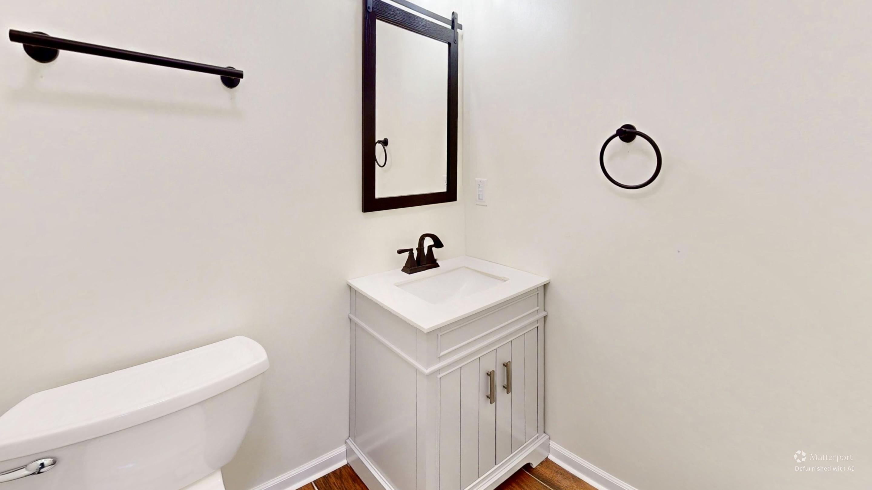 3721 Wirth Road Highland, IN 46322 - Photo 18 of 40 a bathroom with a toilet sink vanity and mirror