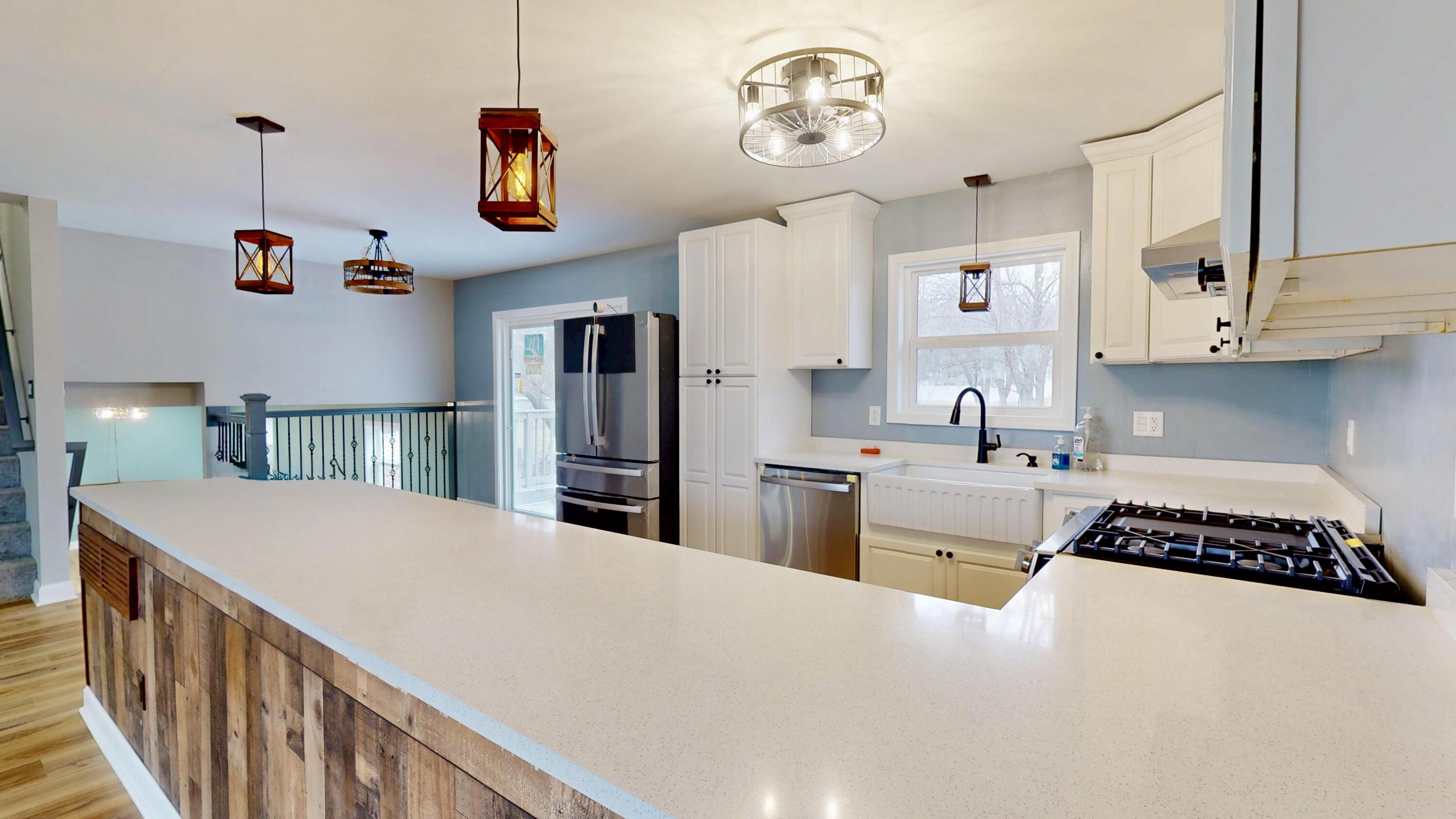3721 Wirth Road Highland, IN 46322 - Photo 6 of 40 a kitchen with stainless steel appliances granite countertop a stove a refrigerator a sink dishwasher and white cabinets with wooden floor