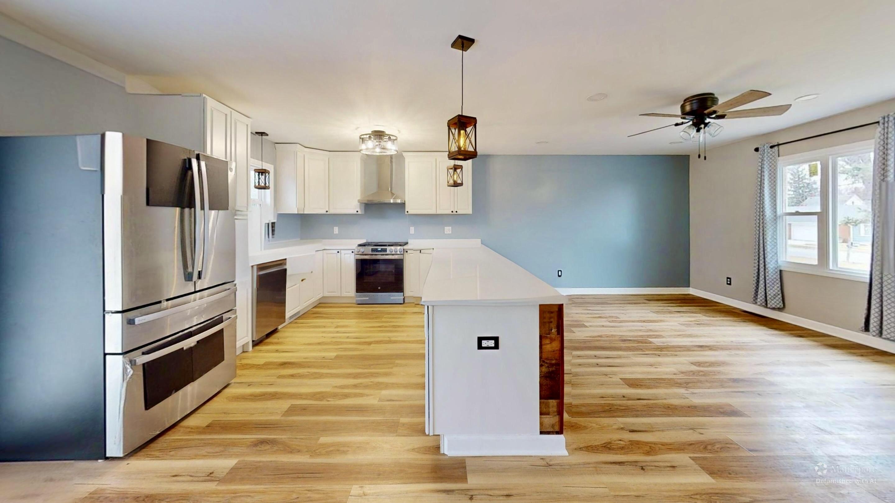 3721 Wirth Road Highland, IN 46322 - Photo 10 of 40 a kitchen with stainless steel appliances kitchen island granite countertop a refrigerator a stove and a sink with wooden floor