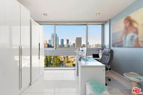 a room with furniture a rug and white walls