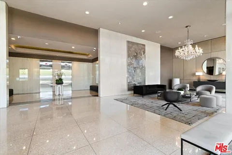 a lobby with furniture and a chandelier
