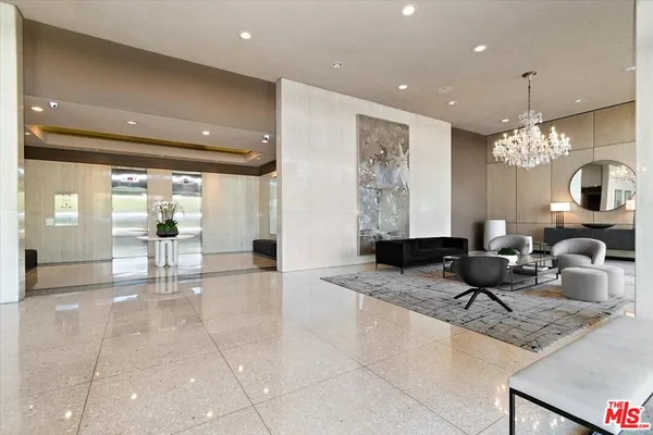 a lobby with furniture and a chandelier