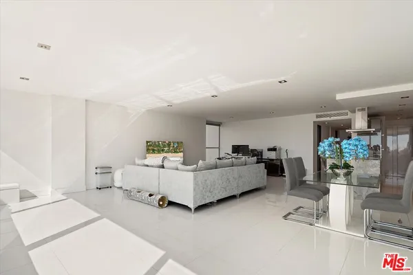 a living room with furniture and white walls