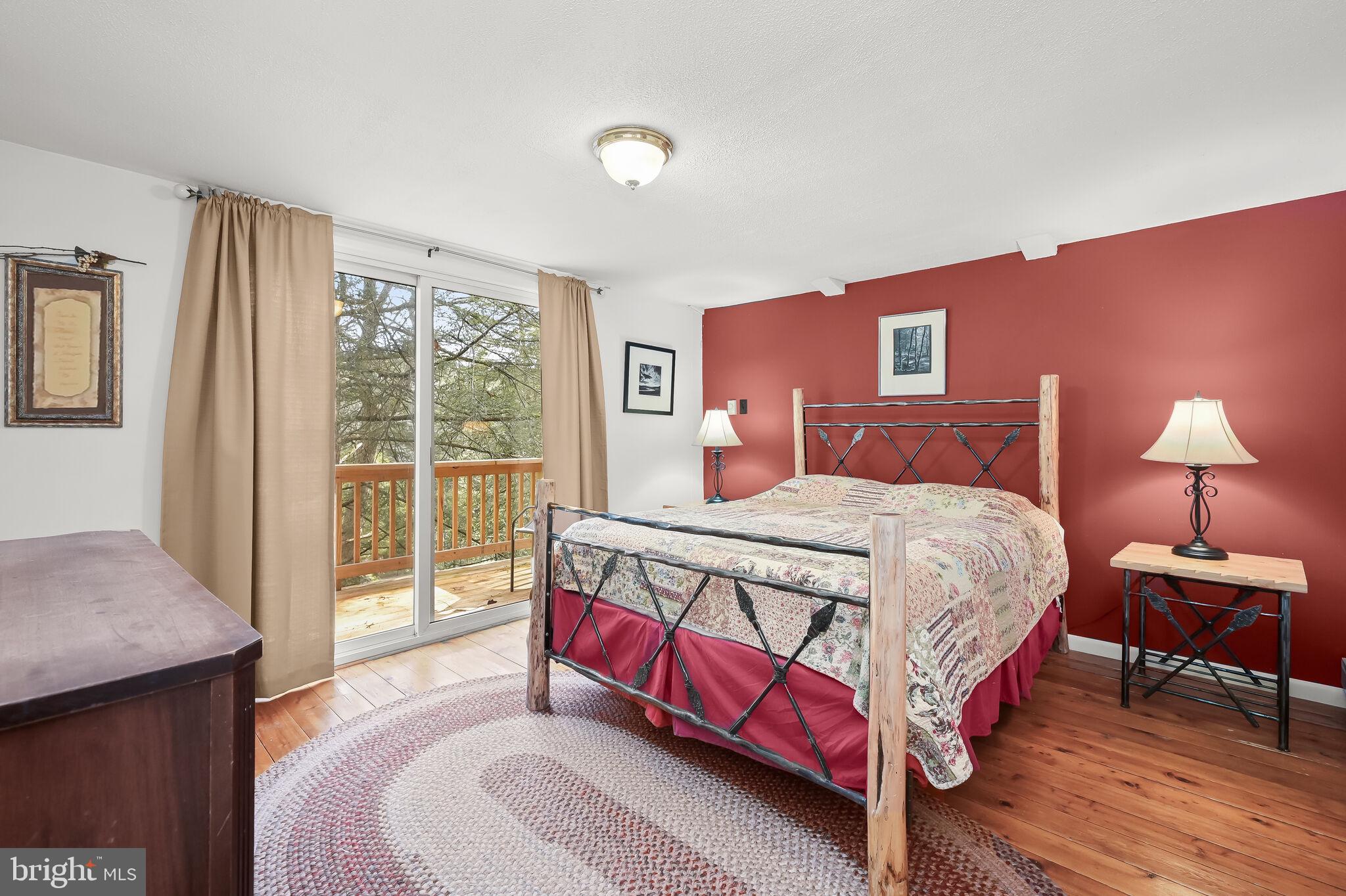 2702 Mayhew Inn Road Oakland, MD 21550 - Photo 33 of 87 Primary Bedroom | Balcony | Hardwood Floors