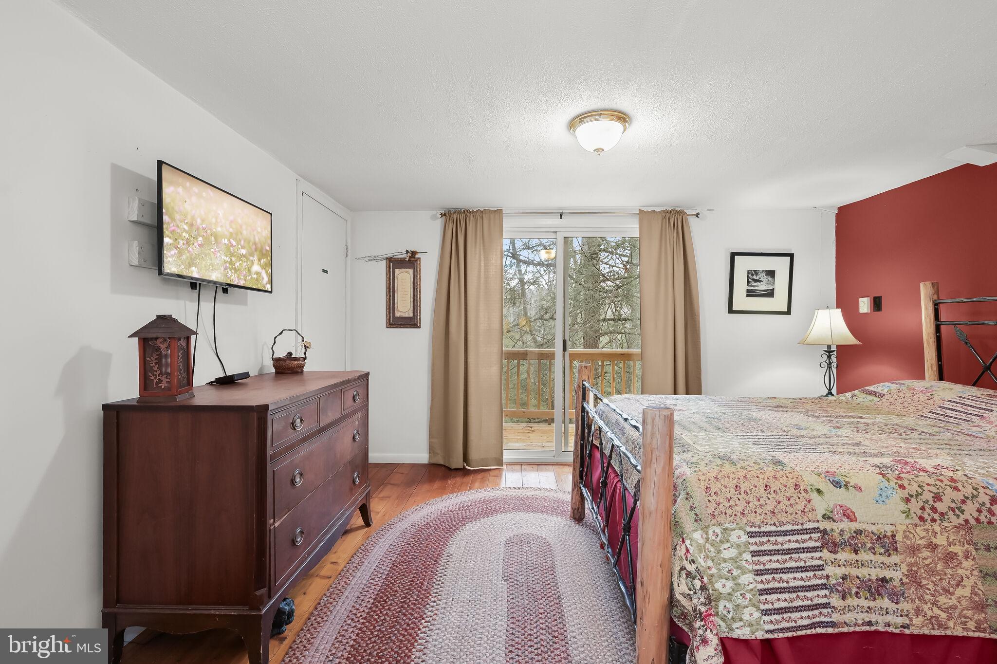 2702 Mayhew Inn Road Oakland, MD 21550 - Photo 34 of 87 Primary Bedroom | Balcony | Hardwood Floors