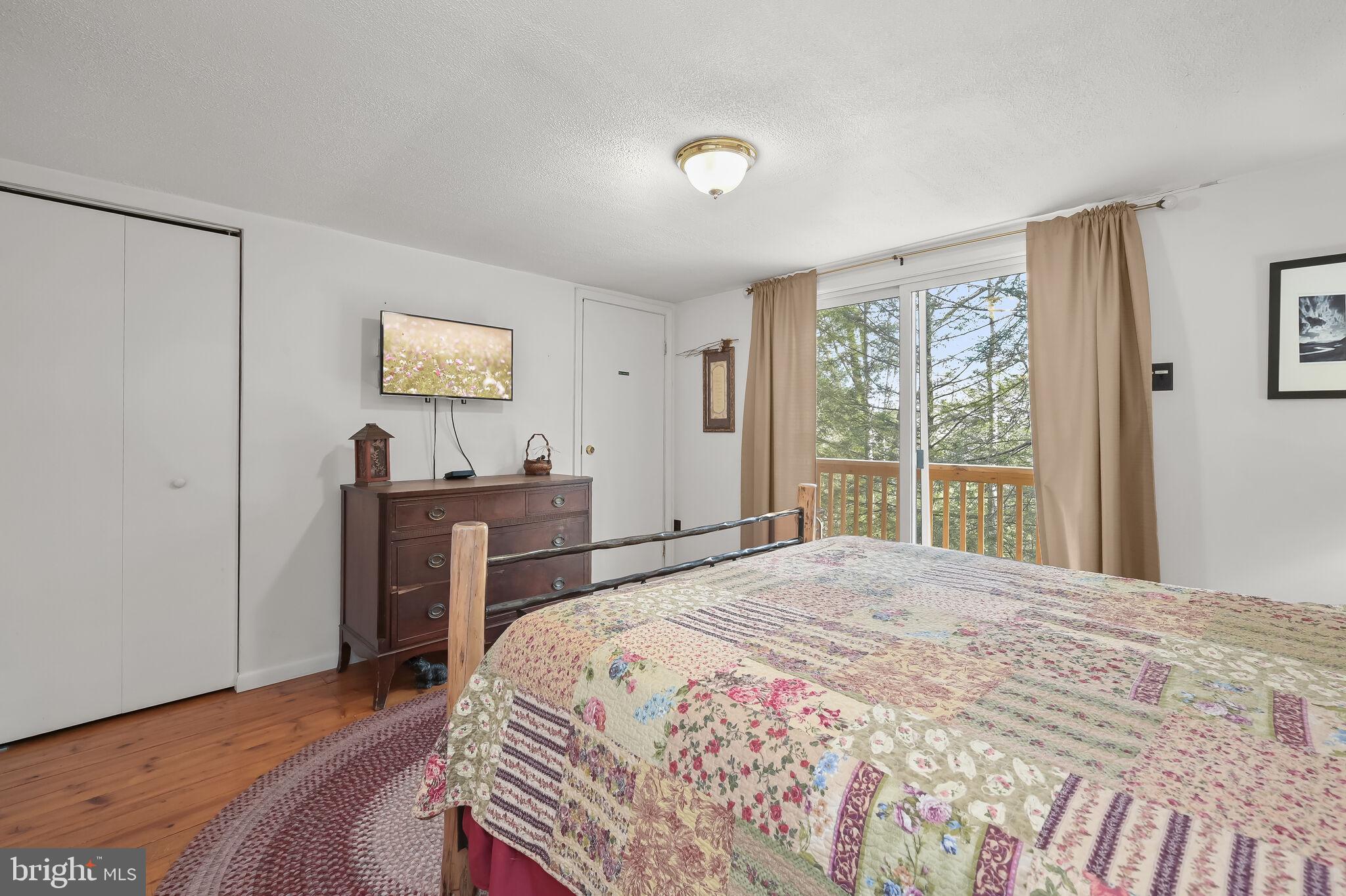 2702 Mayhew Inn Road Oakland, MD 21550 - Photo 37 of 87 Primary Bedroom | Balcony | Hardwood Floors