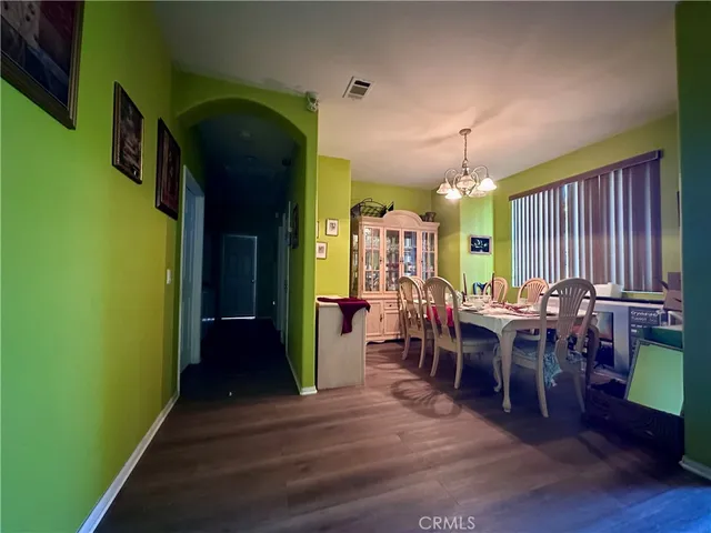 a dining room with furniture and wooden floor