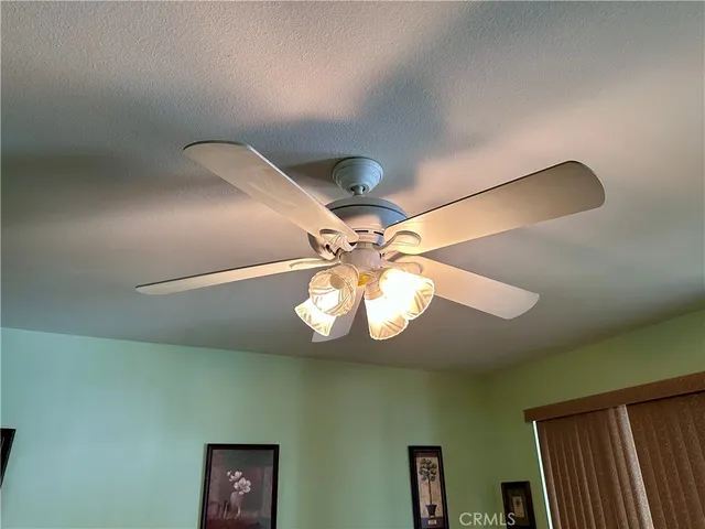a view of a livingroom with a chandelier fan