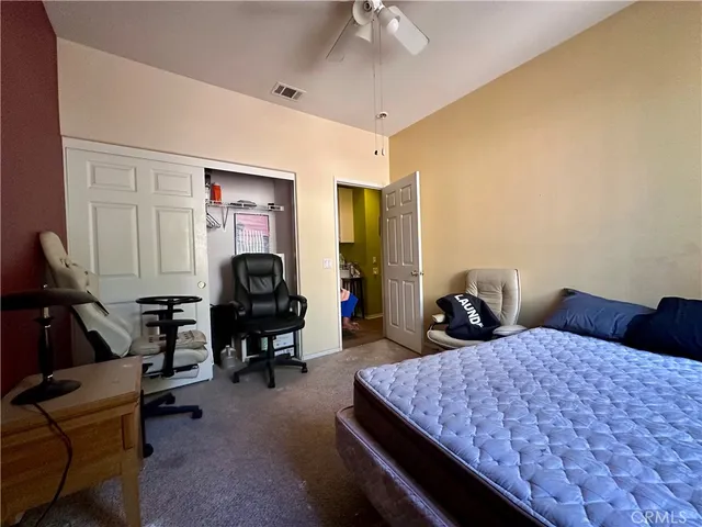 a bedroom with two beds and a lamp