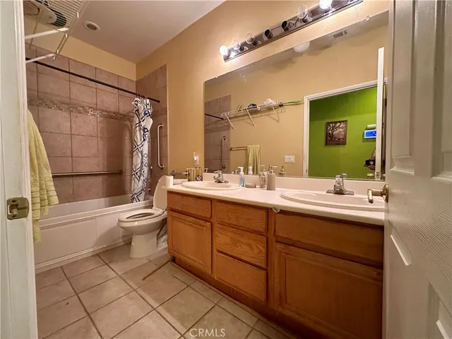 a bathroom with a sink mirror toilet and shower
