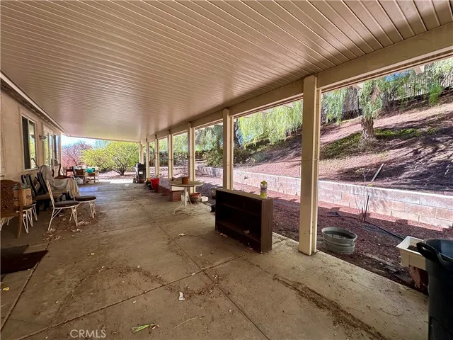 a living room with patio furniture and a floor to ceiling window