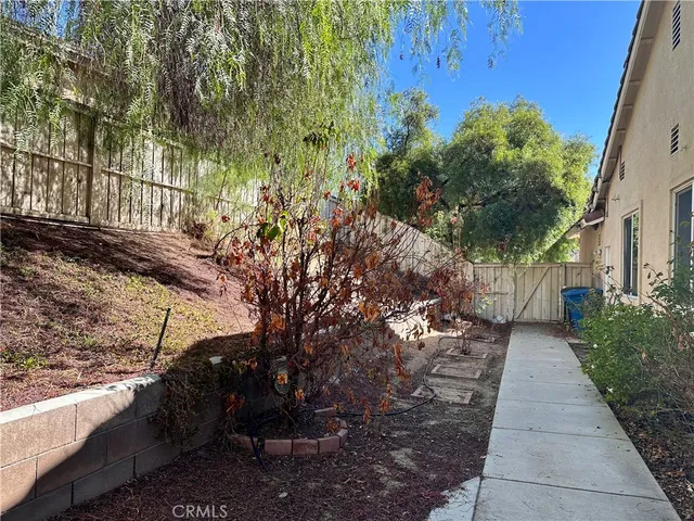 a pathway of a house with a yard
