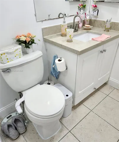 a bathroom with a sink toilet and mirror
