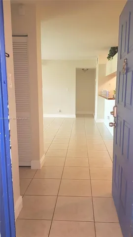 a view of hallway with a couch and a window