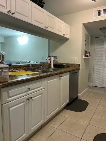 a kitchen with stainless steel appliances granite countertop a sink and a stove