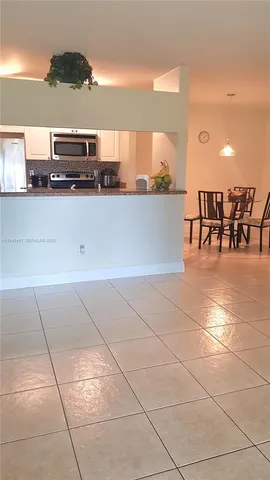 a kitchen with stainless steel appliances a sink and a microwave