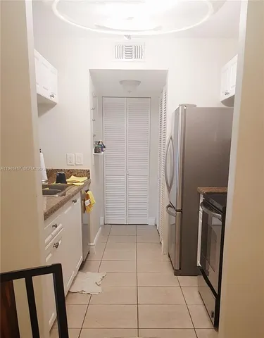 a kitchen with a refrigerator sink and stove