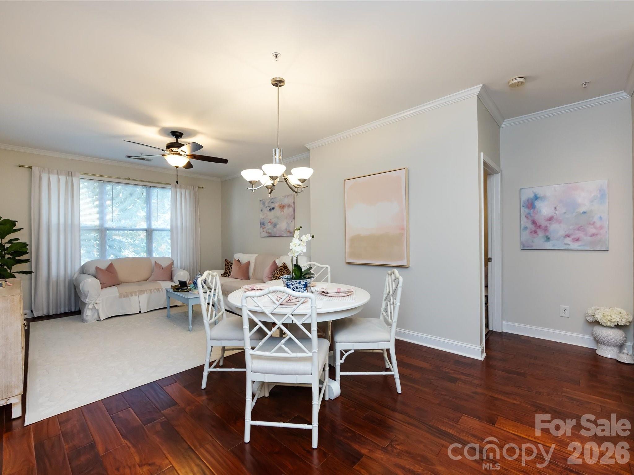 1000 East Woodlawn Road, Unit 113 Charlotte, NC 28209 - Photo 11 of 32 a view of a dining room with furniture wooden floor and chandelier