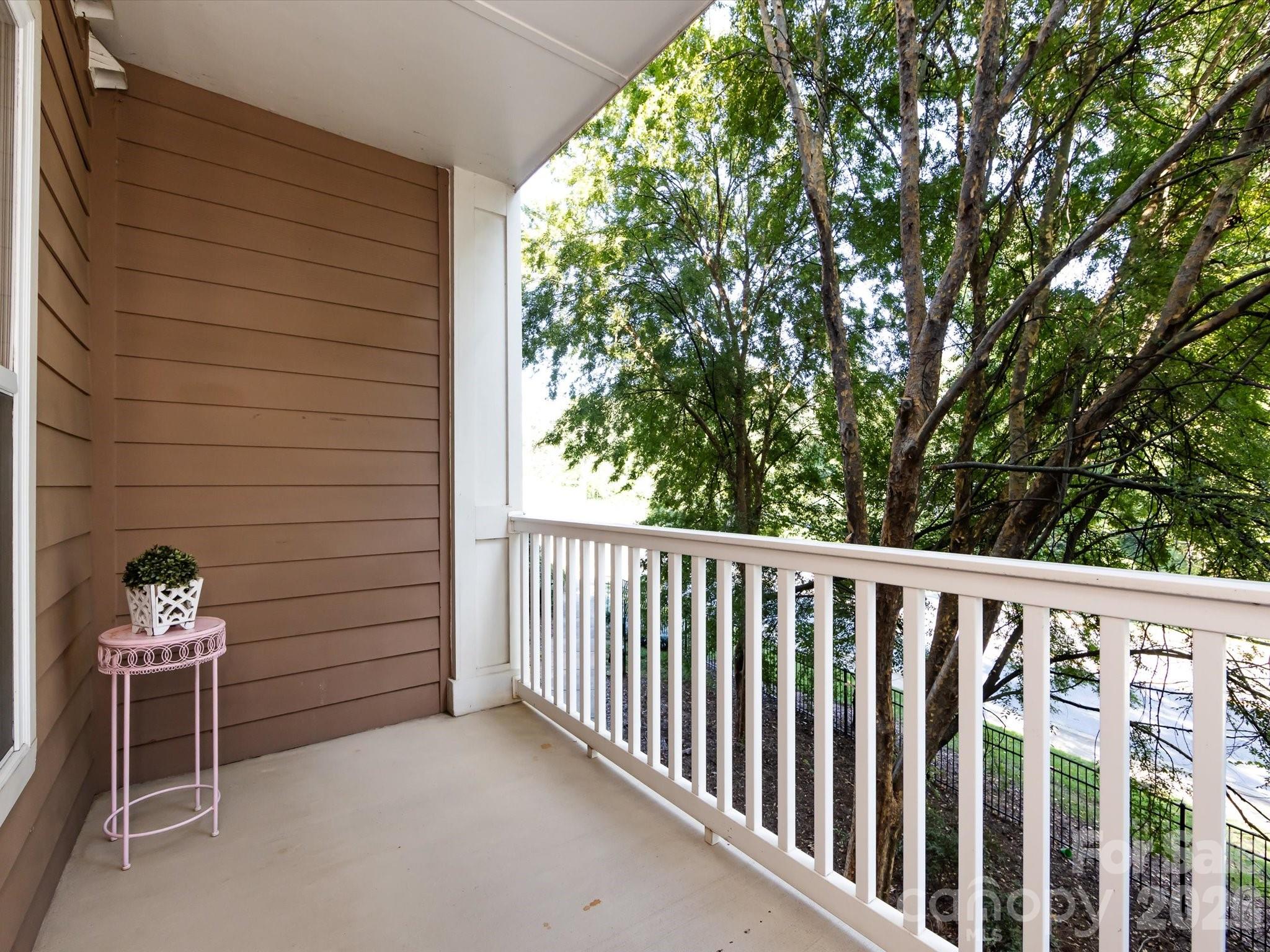 1000 East Woodlawn Road, Unit 113 Charlotte, NC 28209 - Photo 13 of 32 a view of a porch with furniture