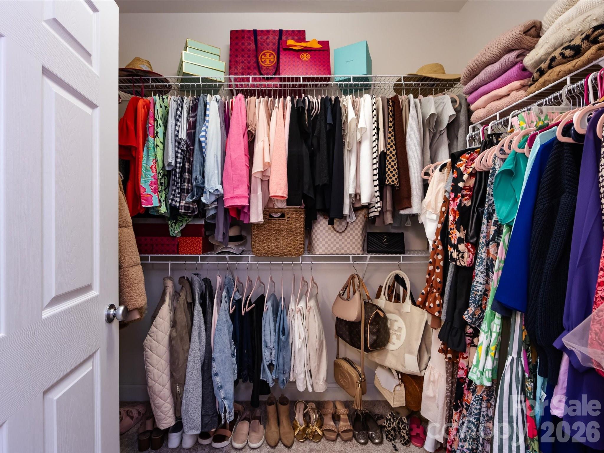 1000 East Woodlawn Road, Unit 113 Charlotte, NC 28209 - Photo 21 of 32 a view of walk in closet with clothes and shoes