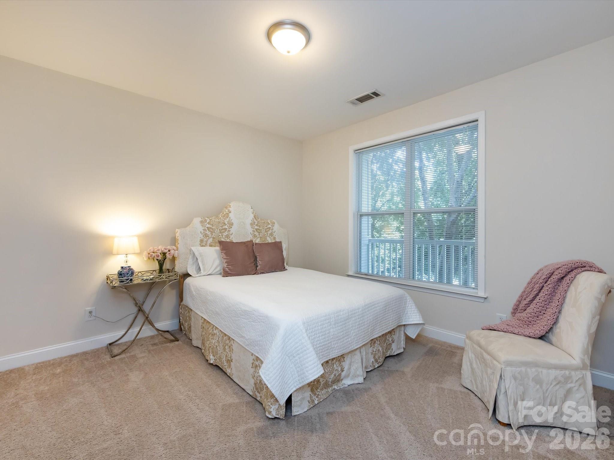 1000 East Woodlawn Road, Unit 113 Charlotte, NC 28209 - Photo 23 of 32 a bedroom with a bed and window