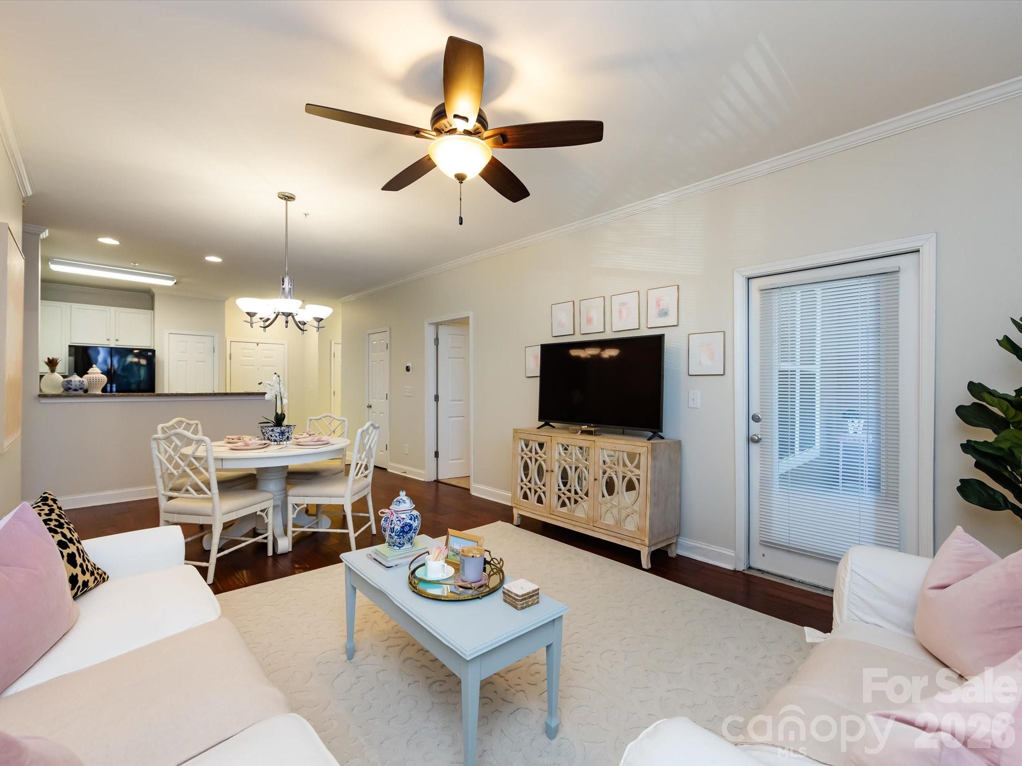 1000 East Woodlawn Road, Unit 113 Charlotte, NC 28209 - Photo 4 of 32 a living room with furniture and a flat screen tv