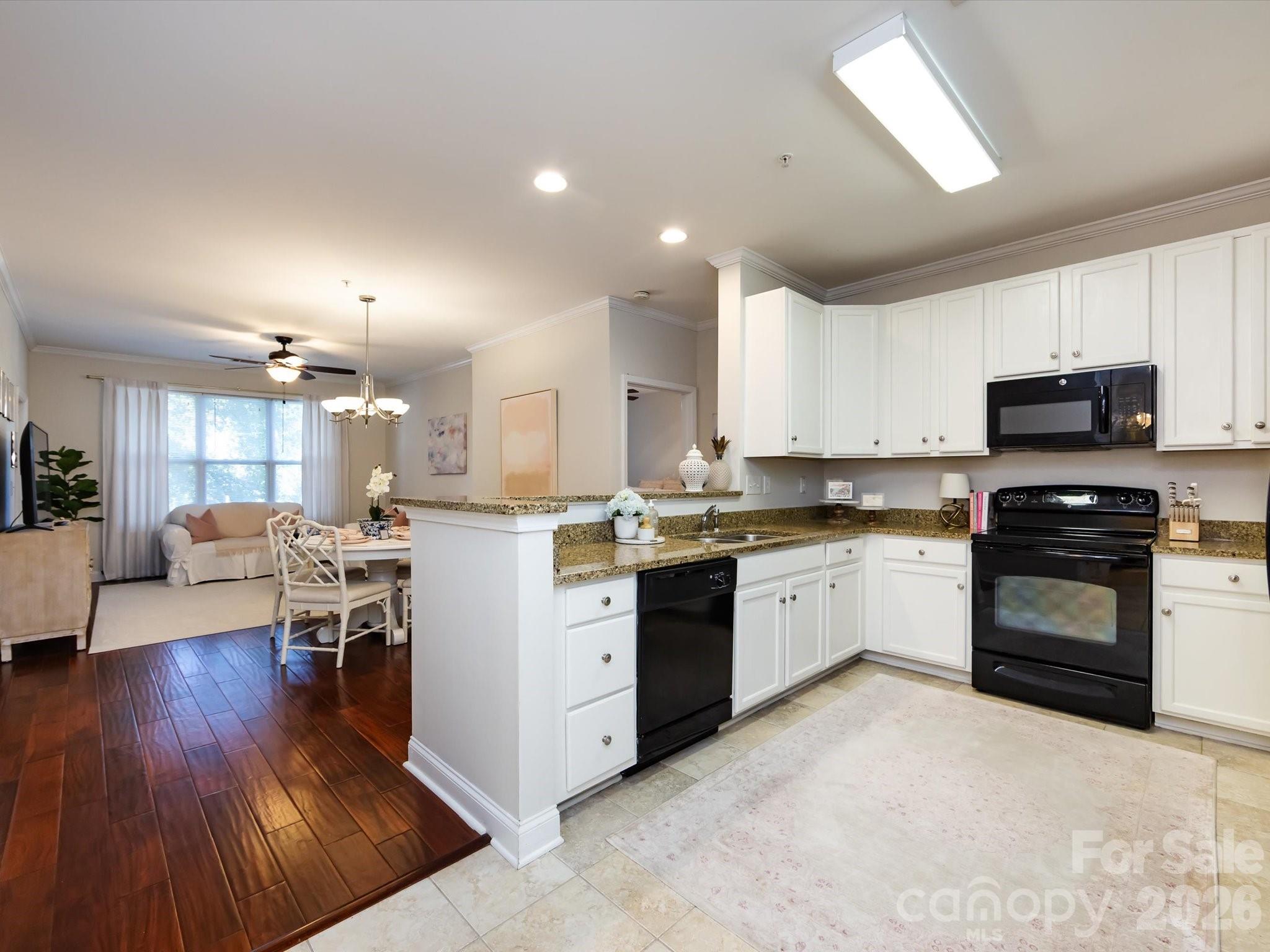 1000 East Woodlawn Road, Unit 113 Charlotte, NC 28209 - Photo 5 of 32 a kitchen with a sink cabinets and wooden floor