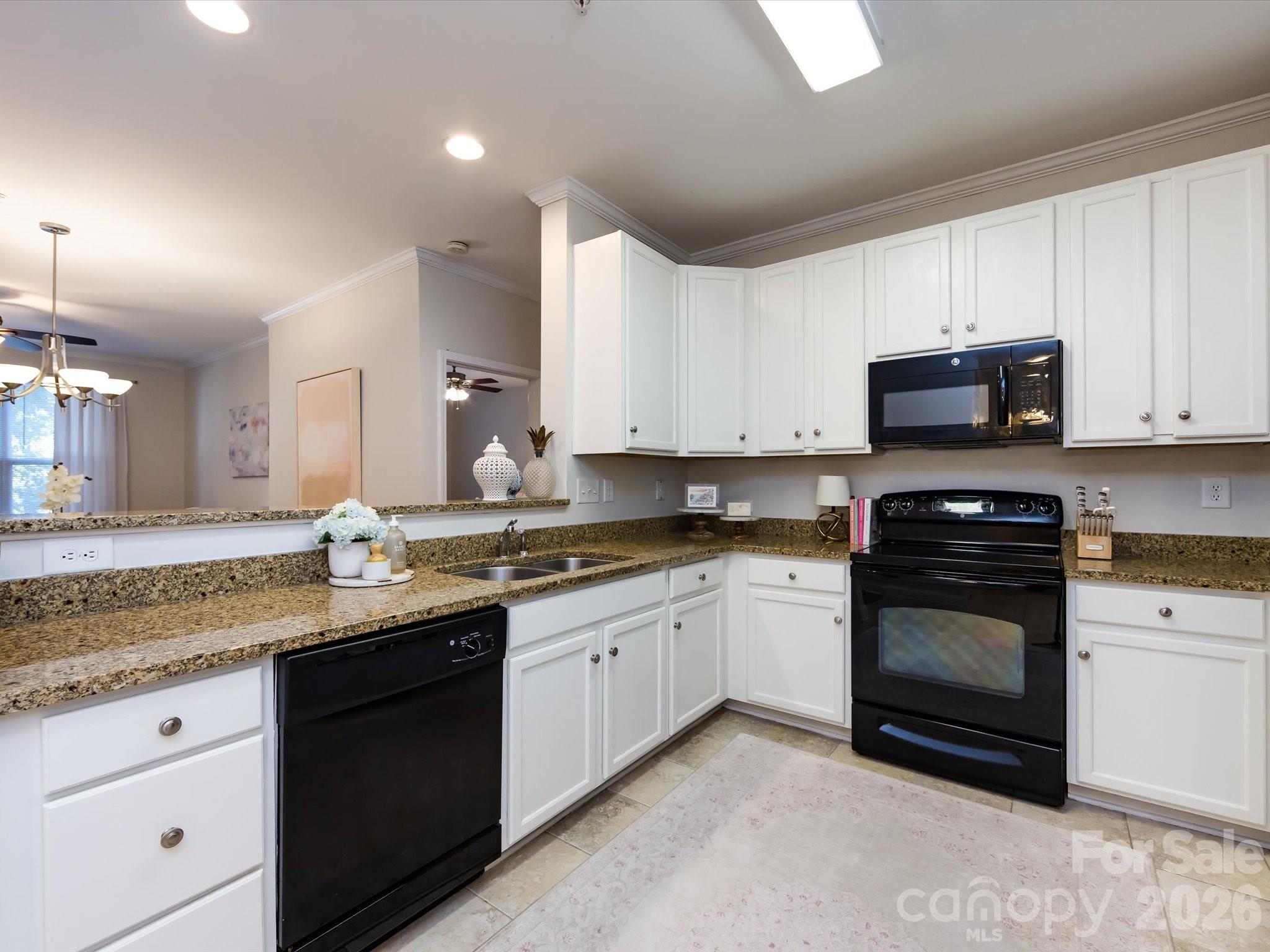 1000 East Woodlawn Road, Unit 113 Charlotte, NC 28209 - Photo 7 of 32 a kitchen with a sink stove and microwave