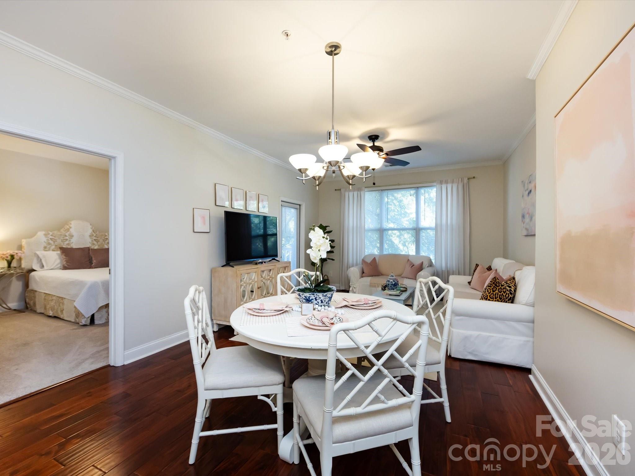 1000 East Woodlawn Road, Unit 113 Charlotte, NC 28209 - Photo 10 of 32 a view of a dining room with furniture and wooden floor