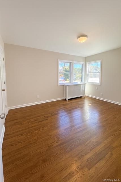 29 Avon Road Hewlett, NY 11557 - Photo 11 of 17 Spare room featuring dark wood-style flooring