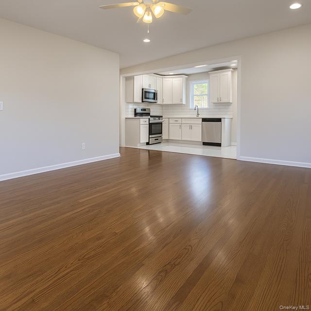 29 Avon Road Hewlett, NY 11557 - Photo 5 of 17 Unfurnished living room with dark wood finished floors, recessed lighting, and a ceiling fan