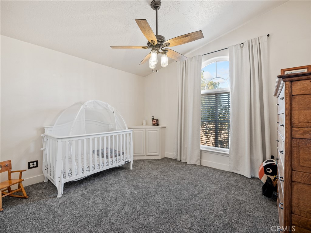 6370 Fremontia Road Hesperia, CA 92344 - Photo 16 of 62 a view of an empty room with chandelier fan and a window